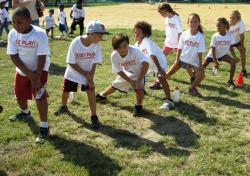 Just Play Day participants warm up at the Winston Wells ballfield. Just Play Day participants warm up at the Winston Wells ballfield.